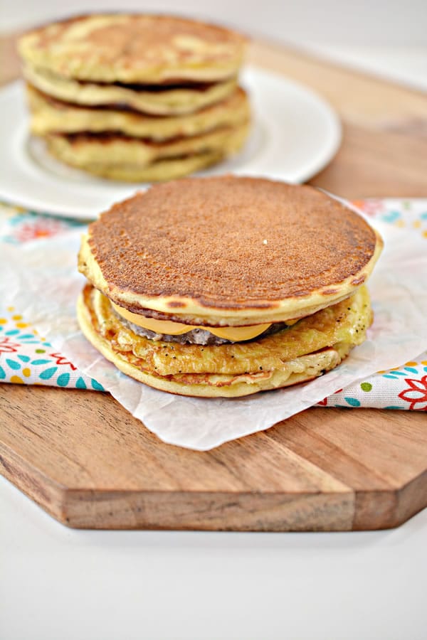 keto fast food recipe - one serving of keto McGriddle breakfast sandwich on a paper napkin atop a marble kitchen counter