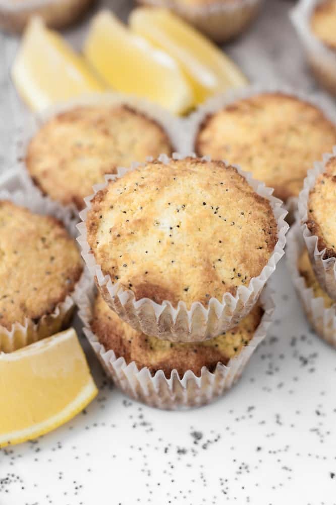 keto-lemon-poppy-seed-muffins-stacked-beside-lemon-wedges