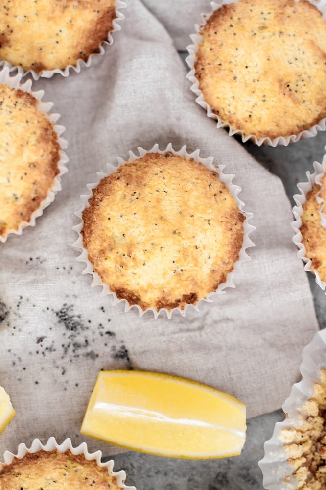 keto lemon poppy seed muffins beside a lemon wedge