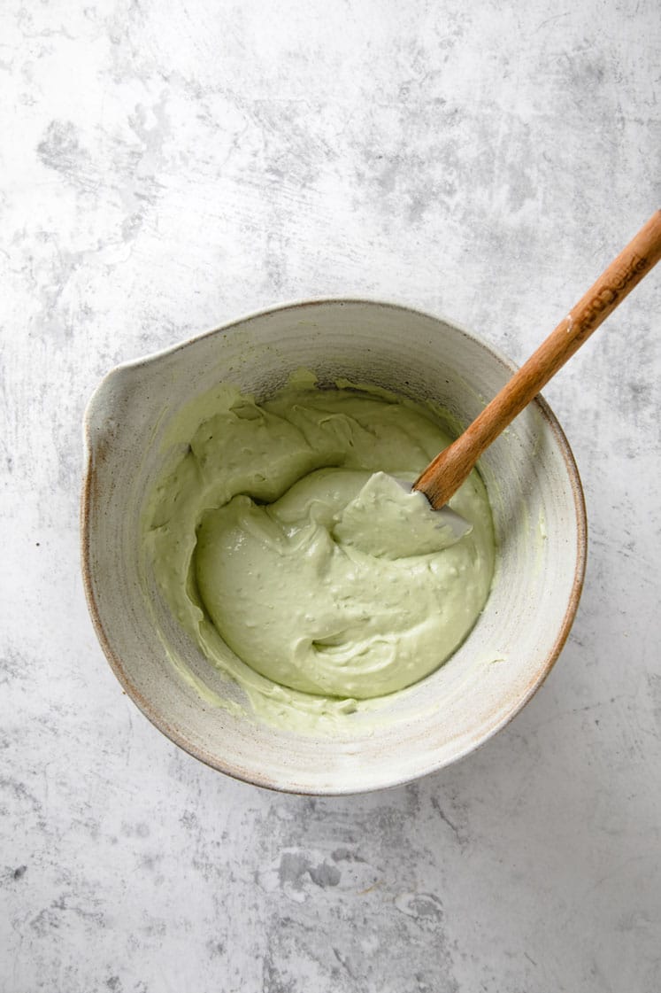 keto key lime pie filling mixture in a bowl atop a marble kitchen counter