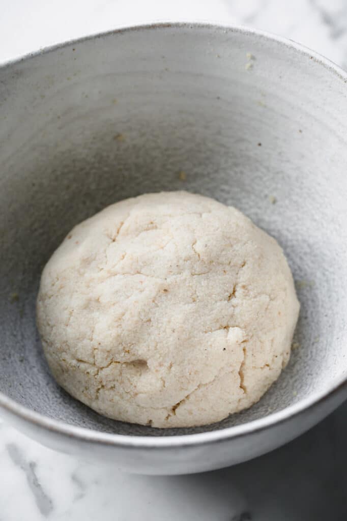 keto naan bread dough shaped into a ball in a mixing bowl