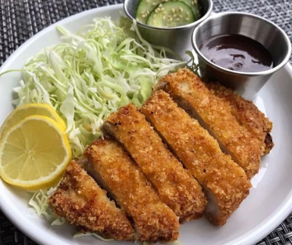 keto tonkatsu on a plate with shredded cabbage on the side