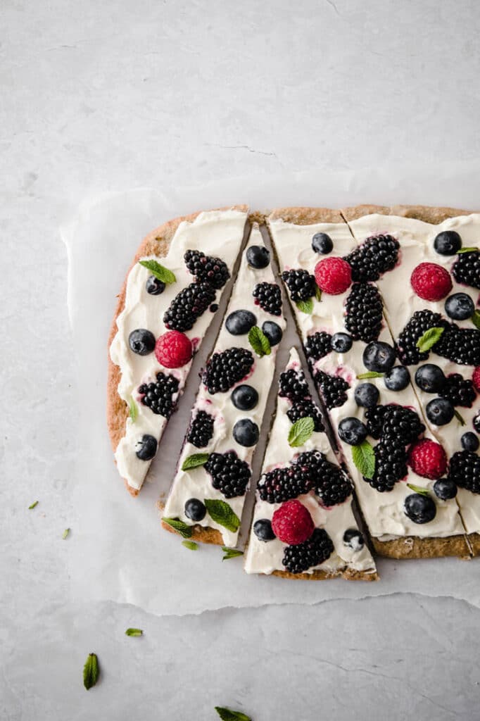 low carb fruit pizza lined horizontally and sliced to form a triangle