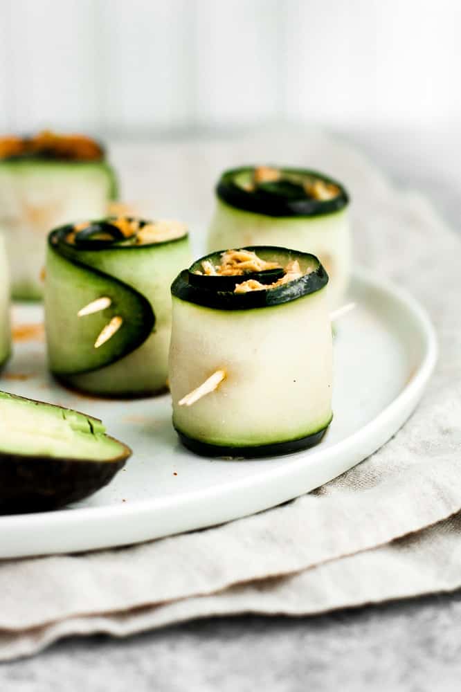 10-minute-spicy-tuna-rolls on a ceramic plate atop a cloth table napkin