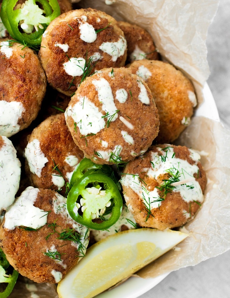 spicy salmon poppers in a bowl lined with parchment paper