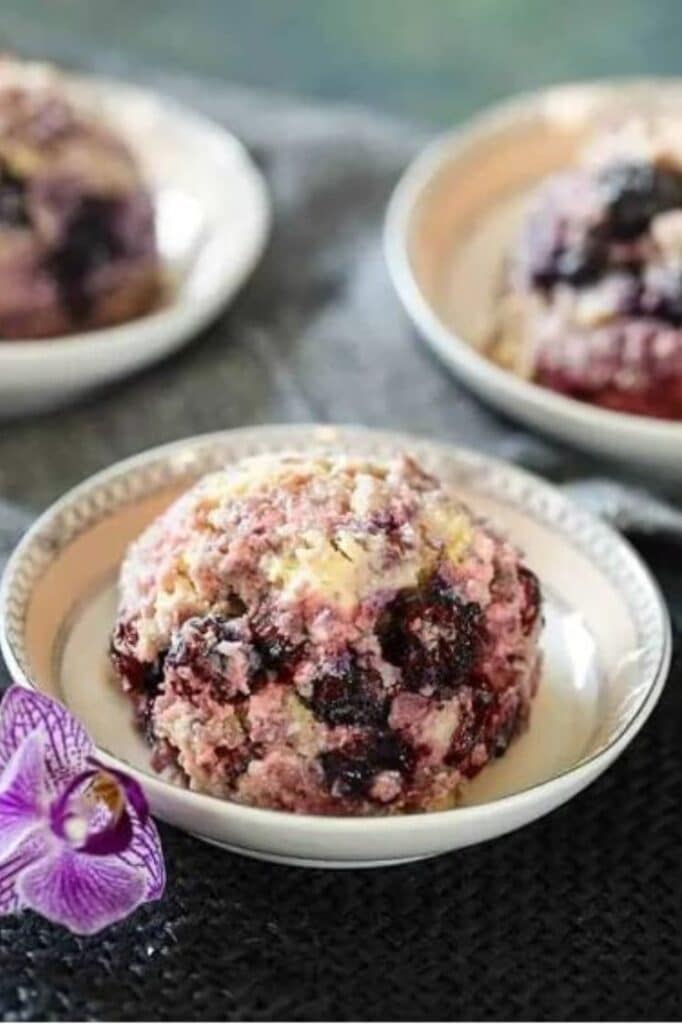 one serving of keto mixed berry ice cream atop a wooden table