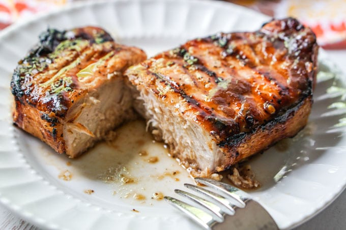 keto father's day recipes close-up image of grilled glazed pork chops slice in half on a plate