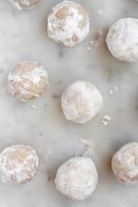 Powdered-Donut-Hole-Fat-Bombs-spread-on-a-marble-counter