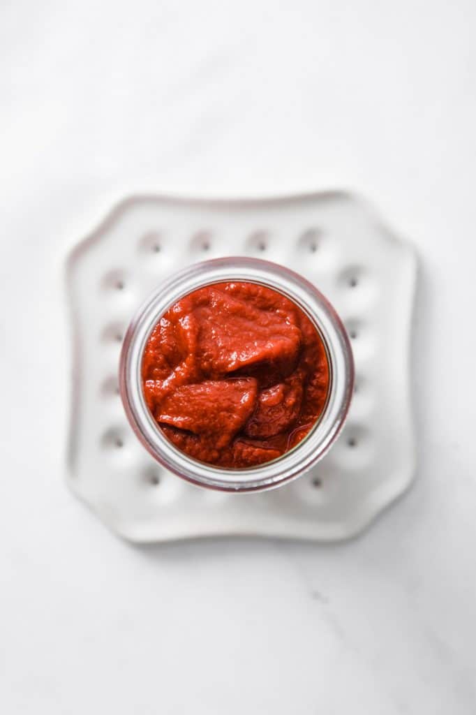 overhead image of a jar of ketchup atop a marble kitchen counter