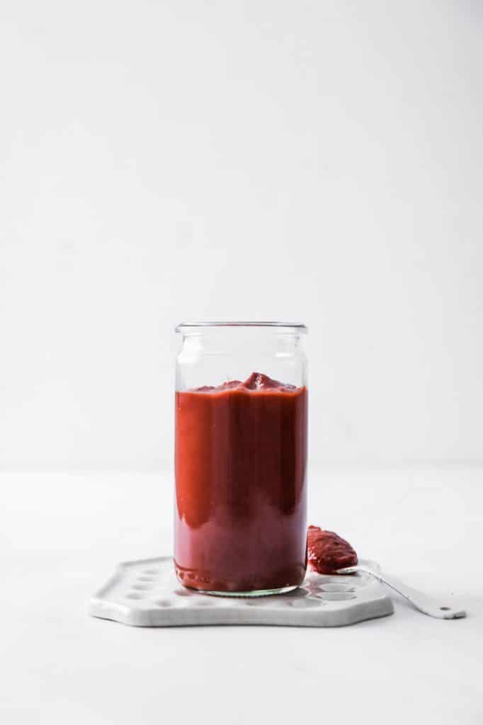 a jar of keto ketchup on a marble kitchen counter