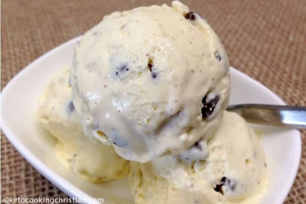 a bowl of Keto Vanilla Chocolate Chip Ice Cream atop a wooden table