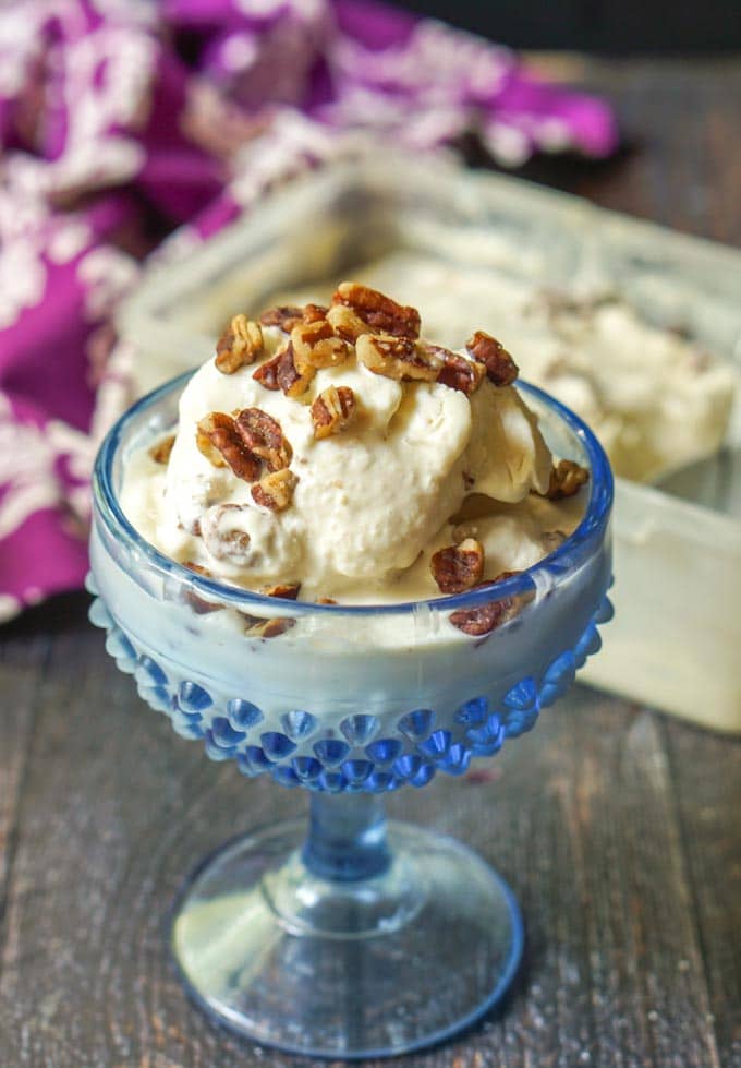 close-up image of a bowl of caramel butter pecan low carb ice cream atop a wooden table