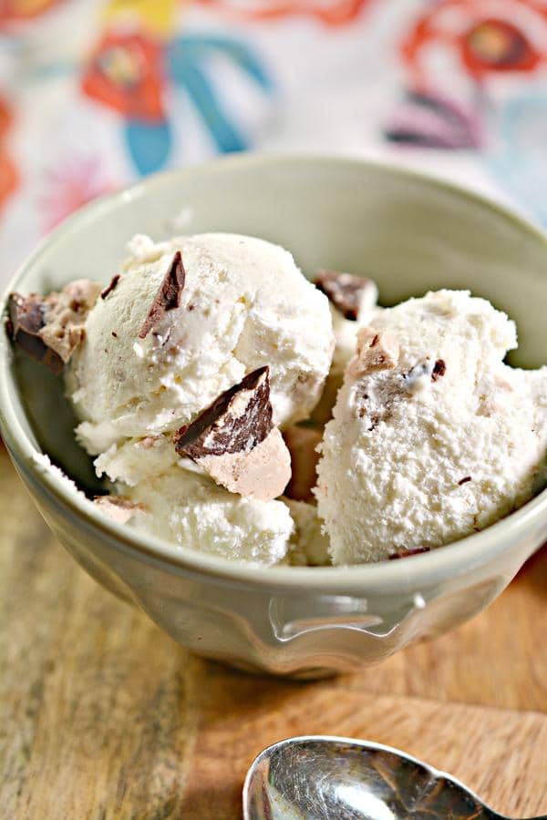 a bowl of keto 3 musketeers ice cream atop a wooden table