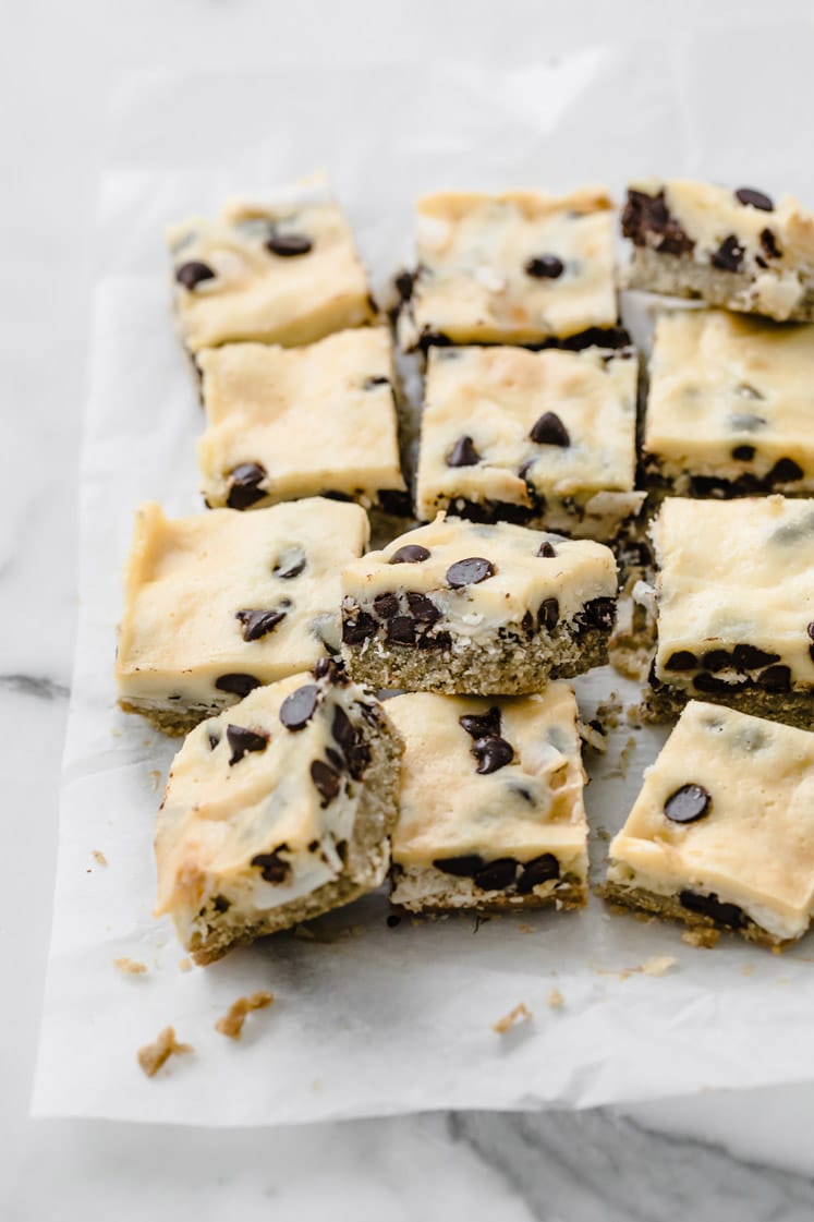 angled overhead image of keto magic bars cut on a baking sheet atop a marble kitchen counter