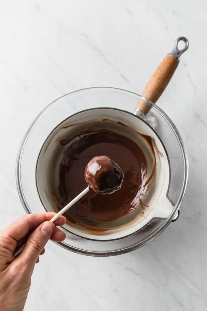 over head image of melted chocolate in a sauce pan atop a marble kitchen counter
