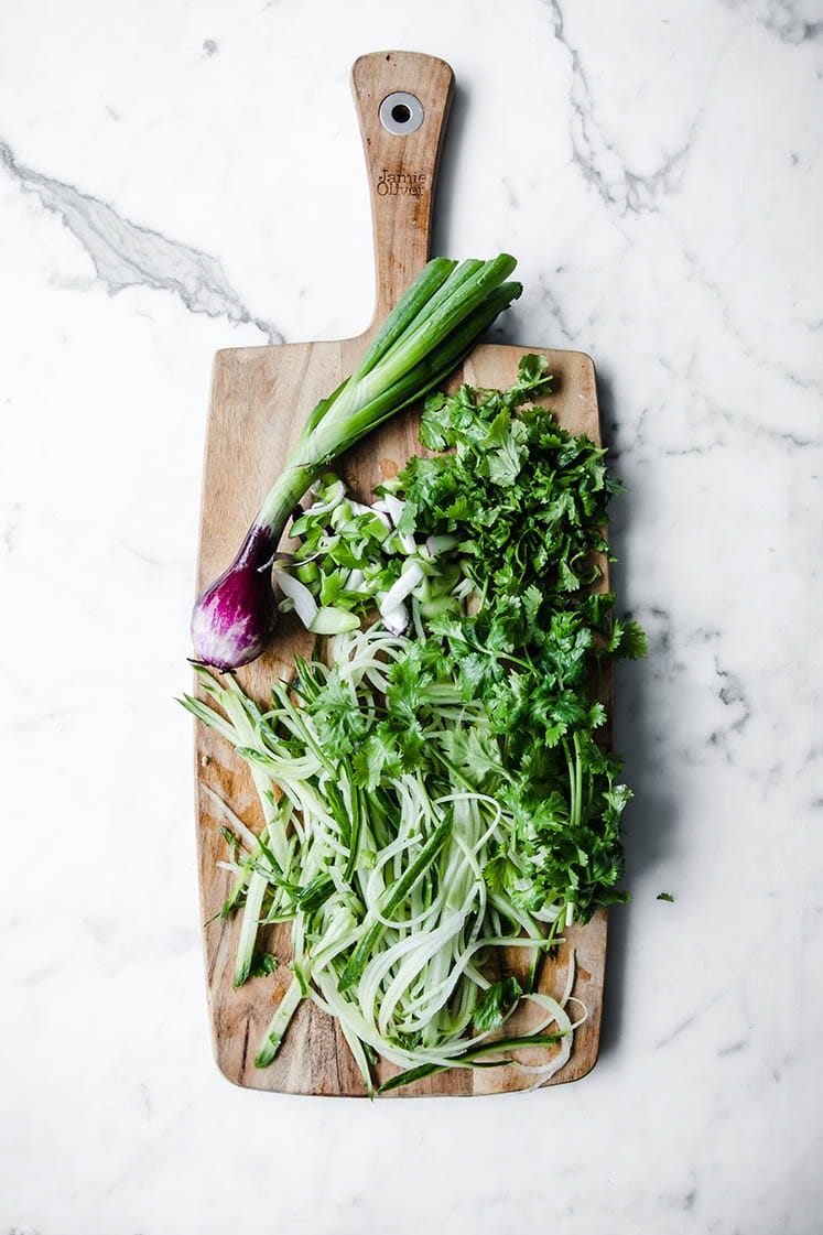 cucumber cut into noodles on chopping board