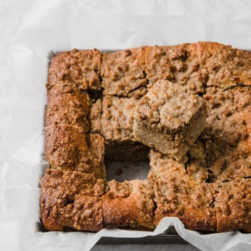 angled image of keto coffee cake sliced into 16 pieces