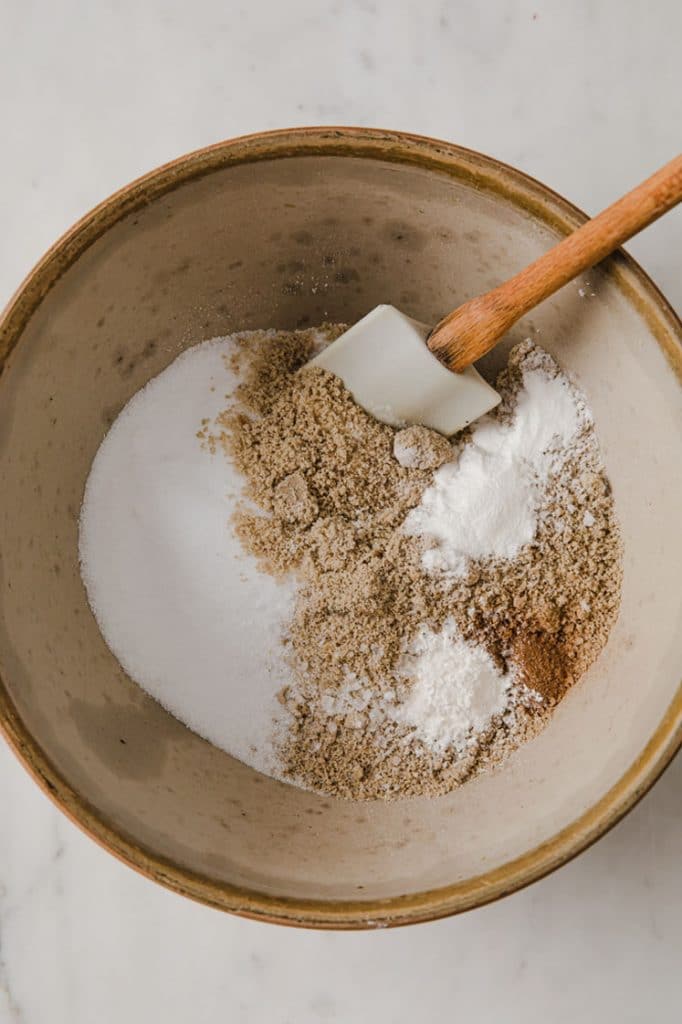 a mixing bowl with ground sunflower seed meal, protein powder, baking powder, cinnamon, and salt