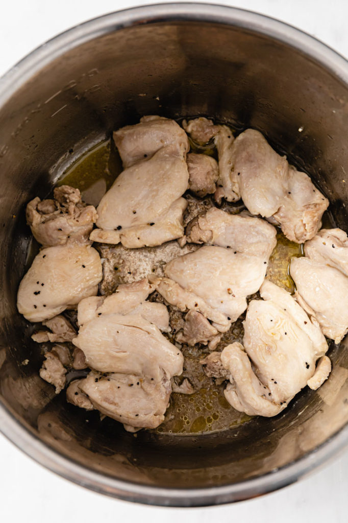 chicken thighs in a instant pot seasoned with salt and pepper
