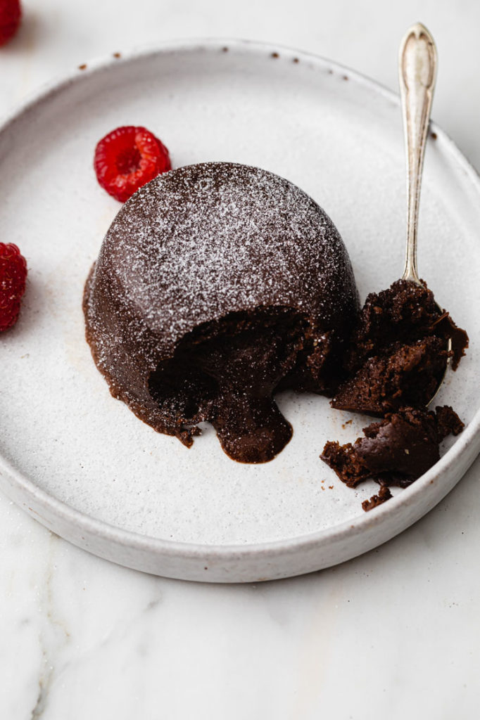 instant pot  chocolate lave cake sprinkled with powdered monk fruit sweetener and garnished with raspberries