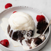 chocolate lave cake topped with keto ice cream and garnished with raspberries