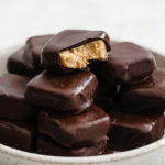 close-up shot of a bowl of Keto Copycat Butterfinger Bites atop a marble kitchen counter