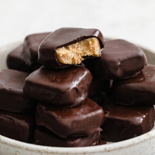 close-up shot of a bowl of Keto Copycat Butterfinger Bites atop a marble kitchen counter