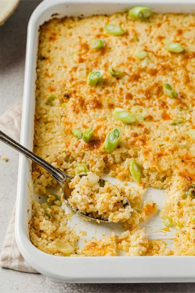 side angle shot of sour cream and onion cauliflower bake with spoon