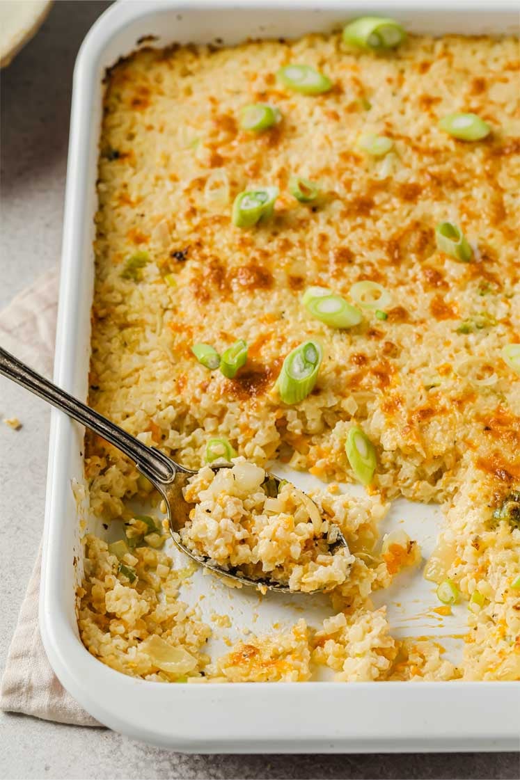 side angle shot of sour cream and onion cauliflower bake with spoon