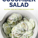 Pinterest Image for Creamy Dill Cucumber Salad. Photo shows overhead shot of a spoonful of mixed cucumbers and red onions tossed in a creamy dill salad dressing