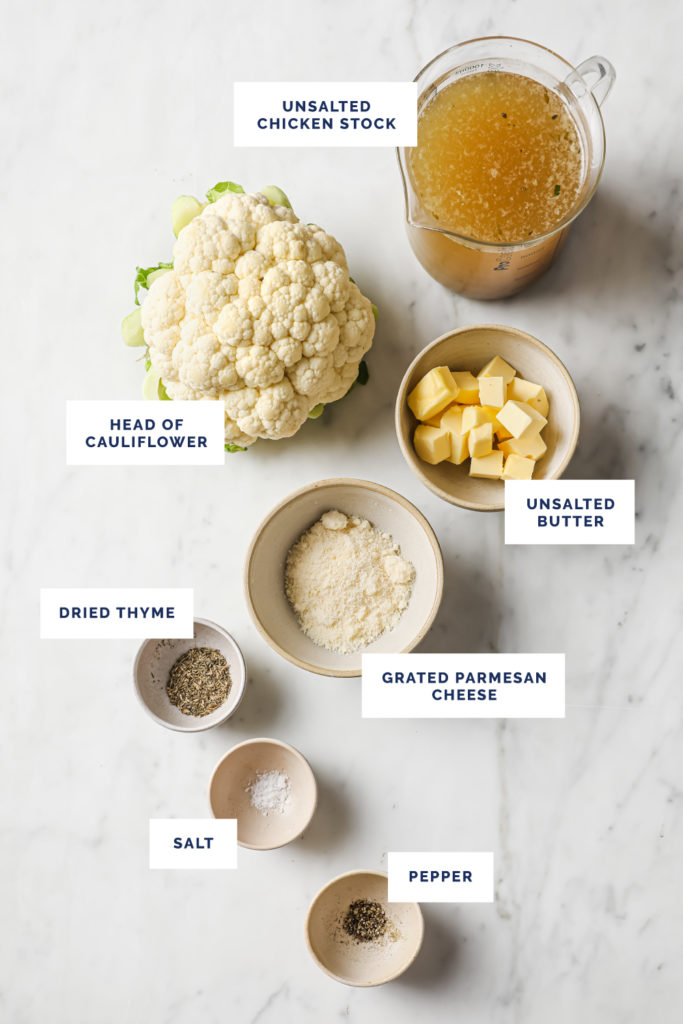 Overhead shot of labeled ingredients for Buttery Roasted Cauliflower on a marble board