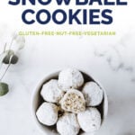 A bowl of nut-free keto snowball cookies, resting on a marble countertop