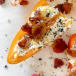 overhead shot of prepared everything bagel mini pepper boats atop white cutting board