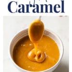 Easy Keto Caramel WordPress Pin. Above the photo, there’s an avocado-green text box with white letters that say: “gluten-free · nut-free · coconut-free” and text in navy blue letters that say: “Easy Keto Caramel”. The photo shows an overhead close-up shot of caramel in a bowl and a spoon held over it. There's caramel dripping under the spoon. Below the photo, there’s text in navy blue letters that say: “realbalanced.com”.