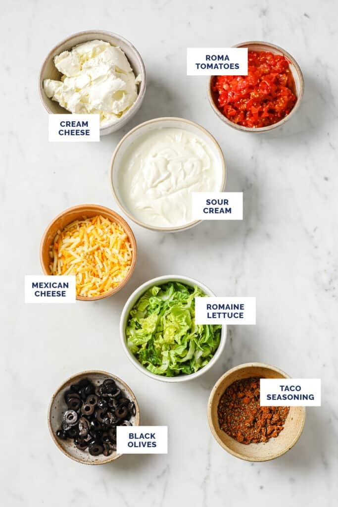 Ingredients in bowls required to make taco dip with cream cheese.