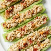 Close-up of Bacon Ranch Chicken Salad Cucumber Boats on a plate atop a marble countertop.