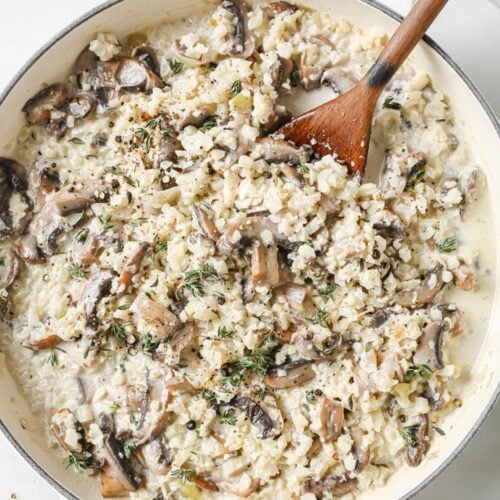 Pan of cauliflower risotto with a wooden spoon.