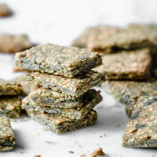 Seed crackers stacked atop a marble counter.