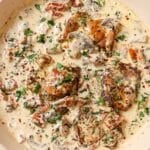 A pan of chicken with creamy mushroom sauce.