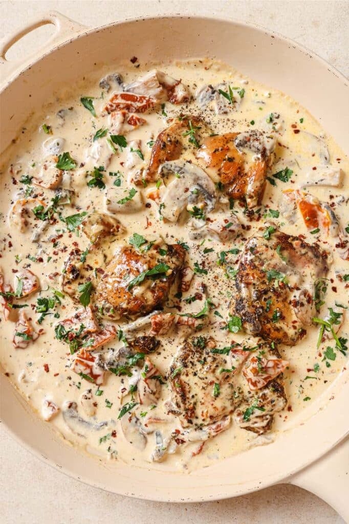 Chicken with creamy mushroom sauce in a skillet.