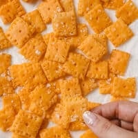 Gluten-free Cheez-Its on a parchment paper-lined baking sheet.