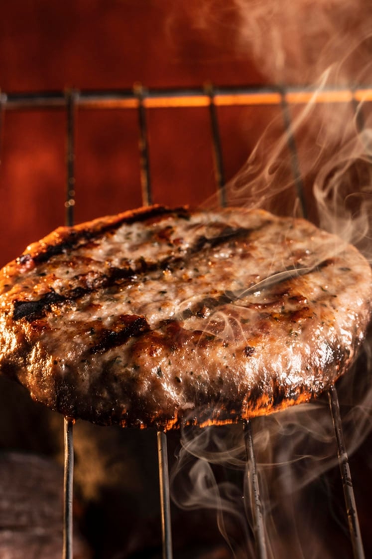 Perfectly grilled burger patties on a pellet griller.