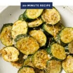 Baked sliced zucchini on a plate with the text baked sliced zucchini 20 minute recipe.