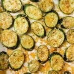 Baked zucchini slices on a baking sheet.