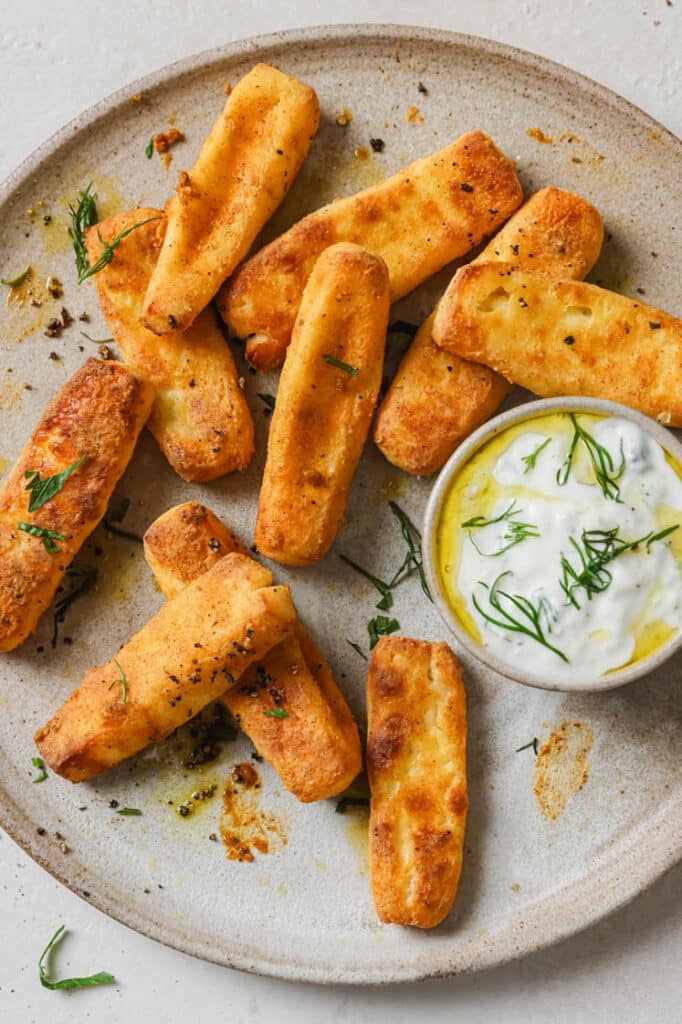 A plate of halloumi fries with a dip.