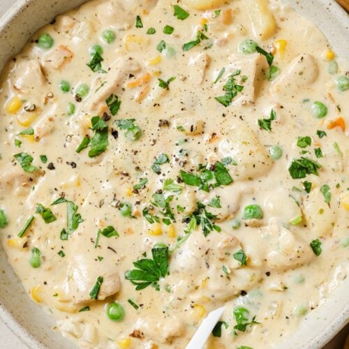 A bowl chicken pot pie soup with a spoon.