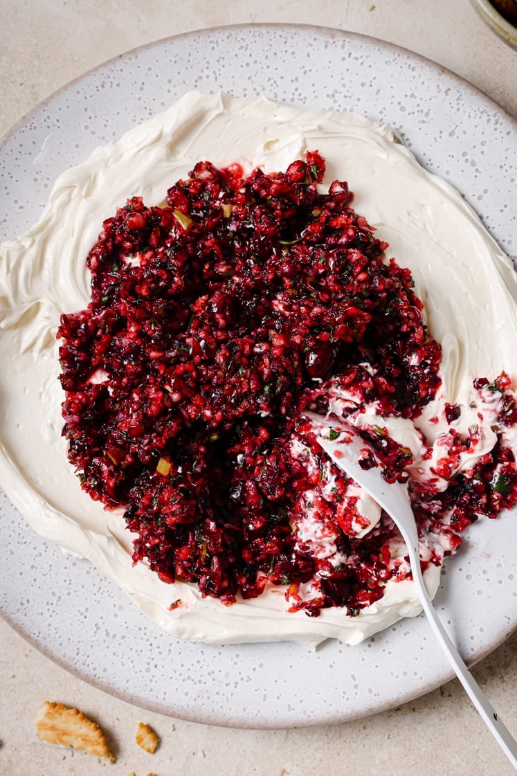 A plate of jalapeño cranberry dip with a spoon.