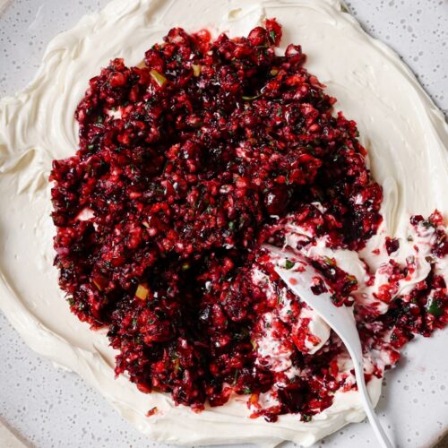 A plate of jalapeño cranberry dip with a spoon.