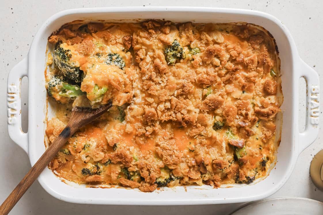 A casserole dish with broccoli and cheese in it.