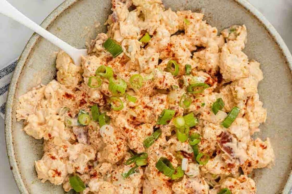 Chicken salad in a bowl with a spoon.